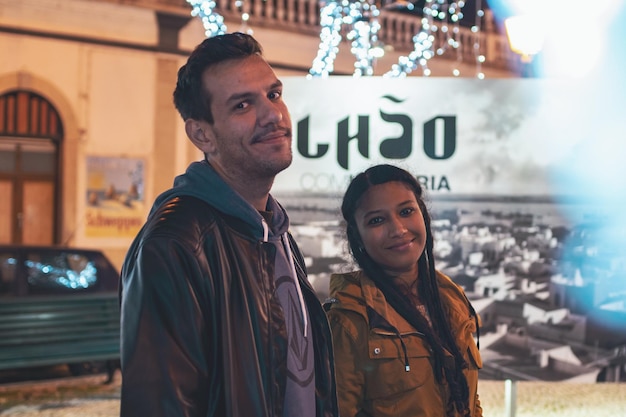 Portrait of young couple standing in city