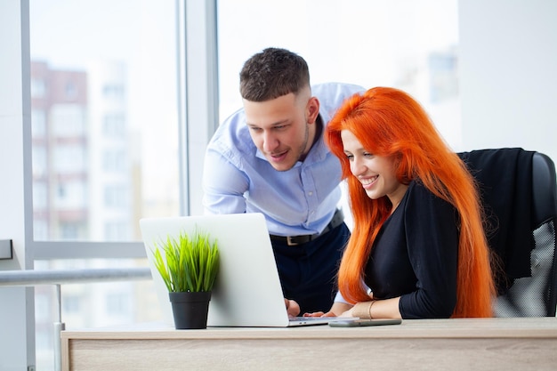 Portrait of young couple workers work in coworking space