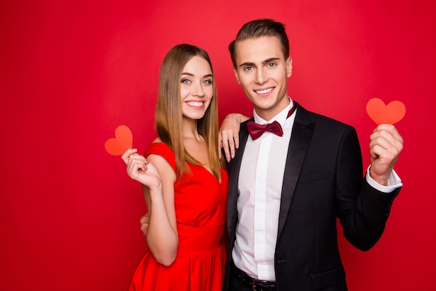 Portrait of young cute couple on a red background