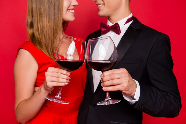 Portrait of young cute couple on a red background