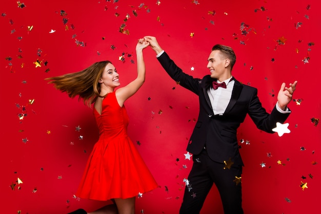 Portrait of young cute couple on a red background