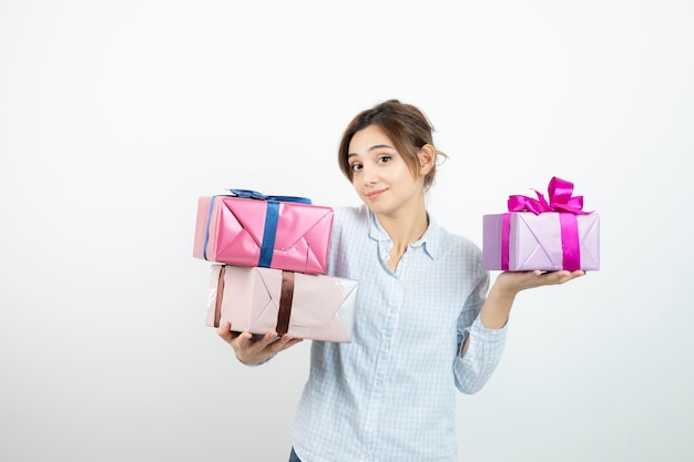 Portrait of a young cute girl holding present box with ribbon. High quality photo