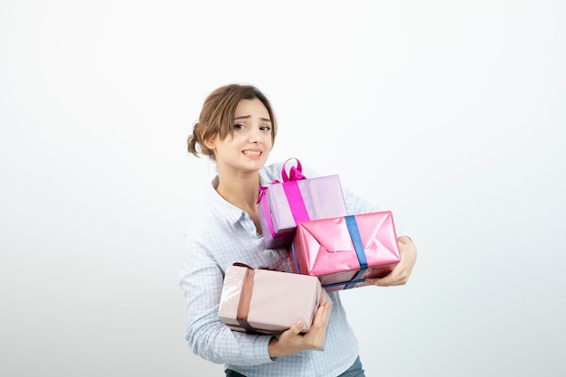 Portrait of a young cute girl holding present box with ribbon. High quality photo