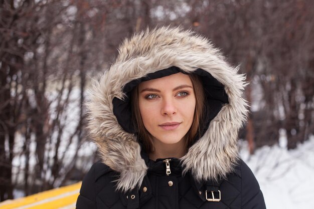 Portrait of young cute woman in winter standing outdoor