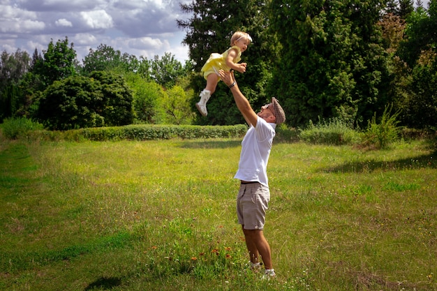 Portrait of young dad having fun with his little daughter