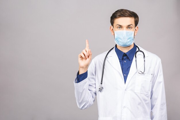 Portrait of young doctor in mask isolated