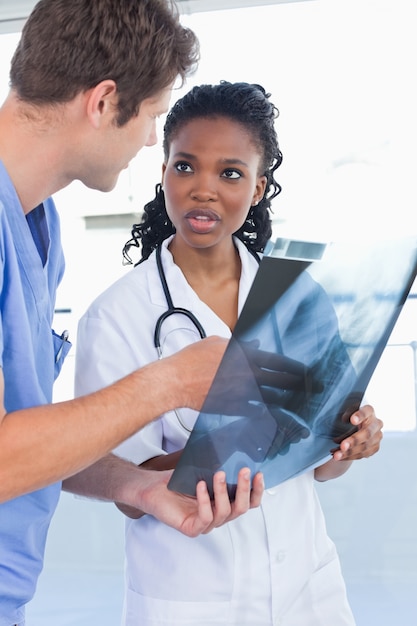 Portrait of young doctors looking at a of X-ray