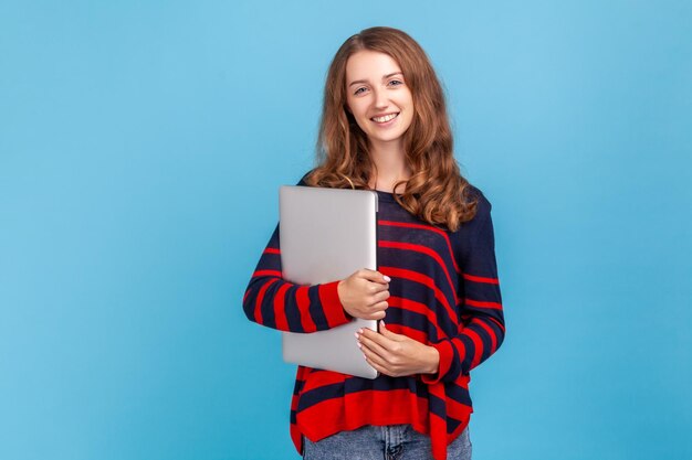 Portrait of young emotional woman on blue background