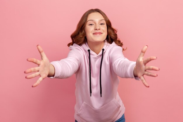 Portrait of young emotional woman on pink background