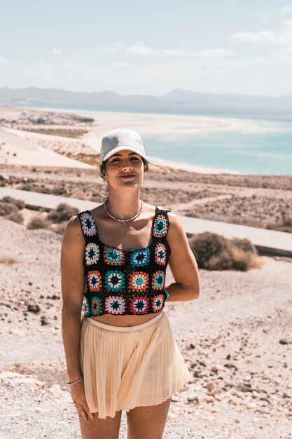 Portrait of a young European woman with an amazing beach in the background on a sunny day