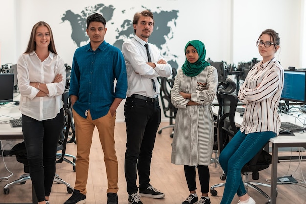 Portrait of young excited multiethnics business team of
software developers standing and looking at the camera at modern
startup office. high-quality photo