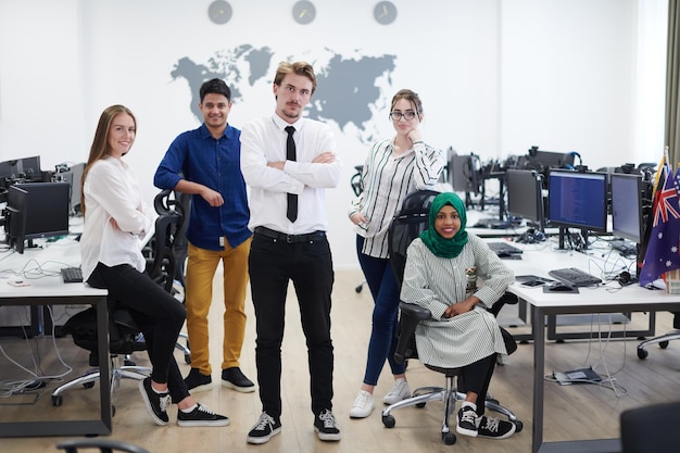 Portrait of young excited multiethnics business team of
software developers standing and looking at camera at modern
startup office