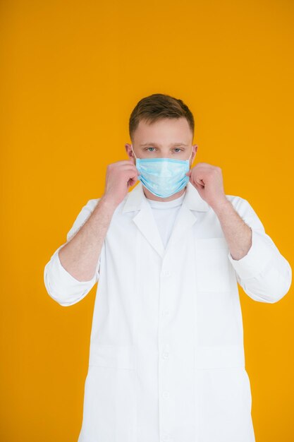 Portrait young exhausted doctor in blue medical mask on face prevention of coronavirus ncov19