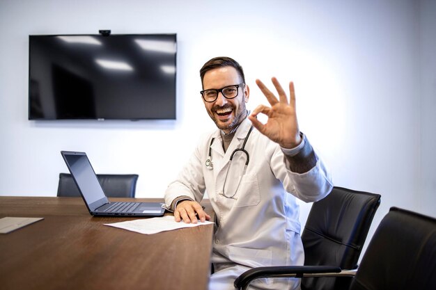 Portrait of young experienced doctor working on the computer in clinic office