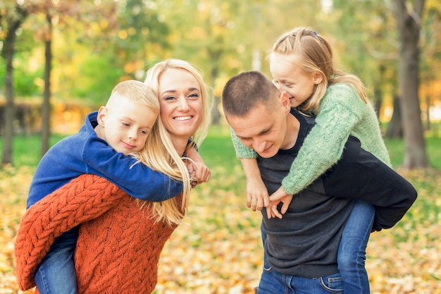 Portrait of young family in autumn park