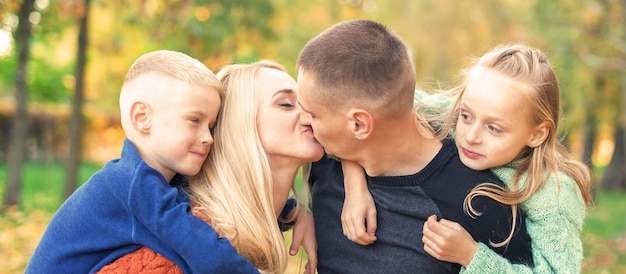 Portrait of young family in autumn park