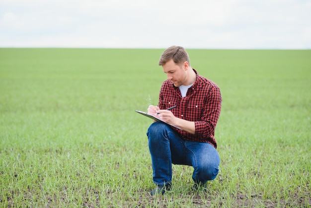 Portrait of a young farmer in a field