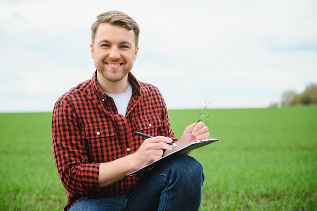 Portrait of a young farmer in a field