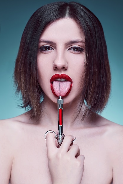 Portrait of young fashion woman with injector