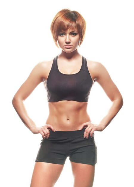 Portrait of young female athlete looking at camera, isolated, white background.Studio shot