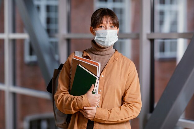 Portrait of young female student wearing a medical mask