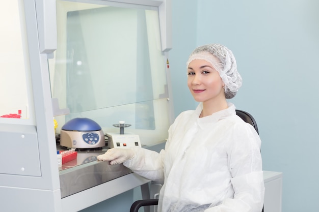 Portrait of young female technician in laboratory of genetics