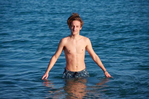 A portrait of a young fit caucasian male in the sea