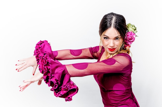 Portrait of young flamenco dancer in beautiful dress with white isolated background