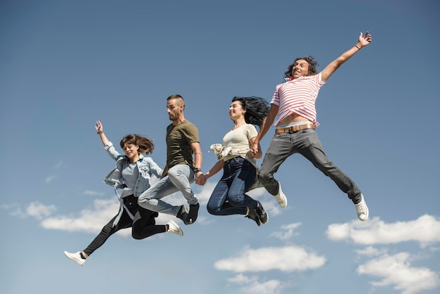 Photo portrait of young friends jumping from jetty