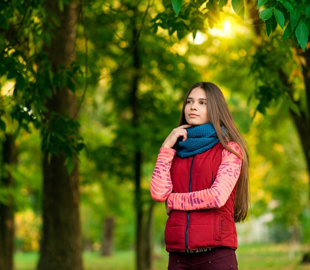 Portrait of a young girl in the autumn park