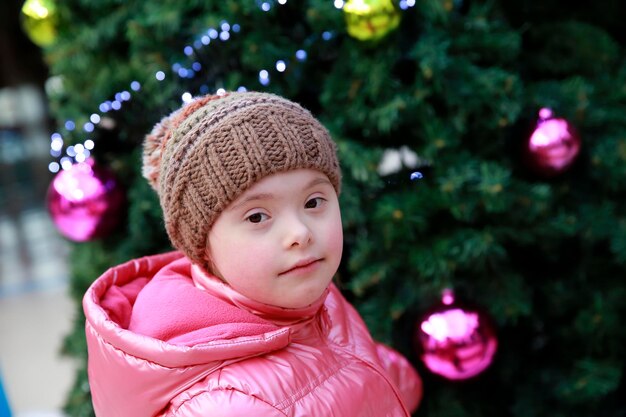 Portrait of young girl on background of the christmas tree