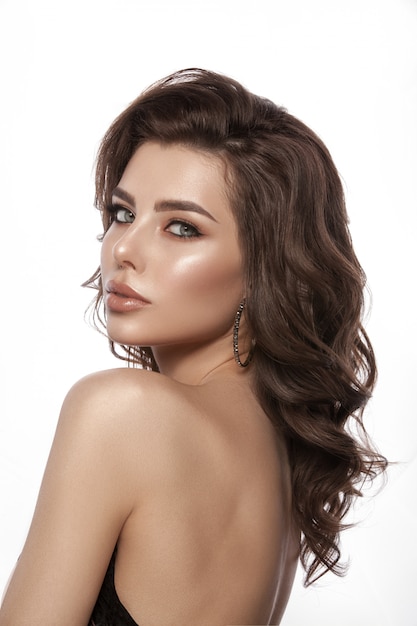 Portrait of a young girl. Beautiful healthy hair, hair curls, natural make-up and lip color, glamorous image. Isolated