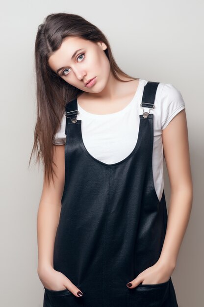 portrait of a young girl in black overalls