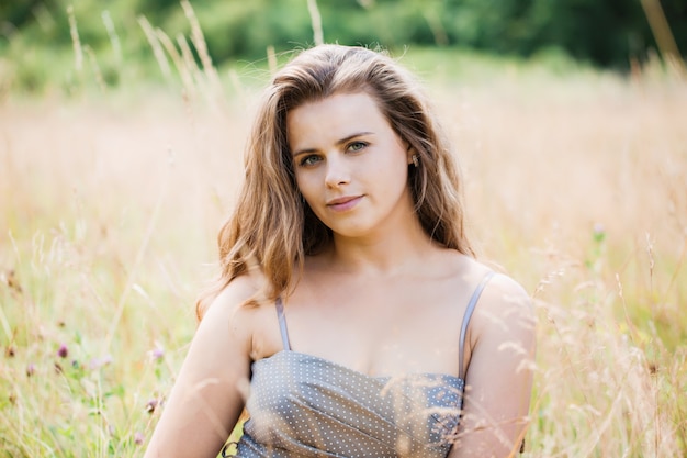 Portrait of a young girl in a field, close-up