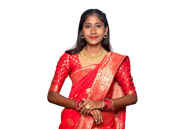 Portrait of a young girl on Indian traditional saree posing on a white background