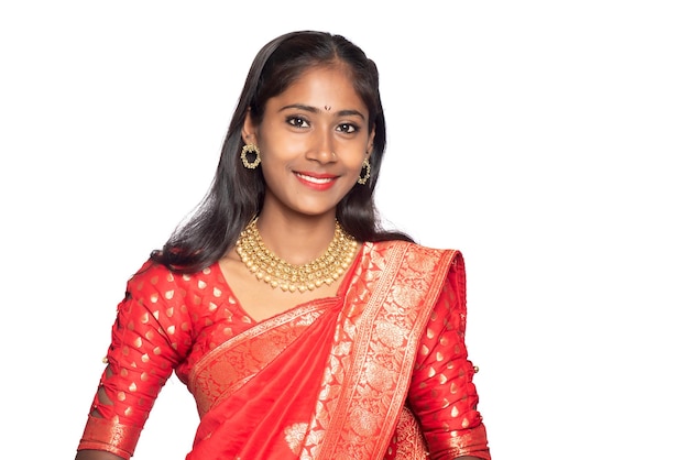 Portrait of a young girl on Indian traditional saree posing on a white background