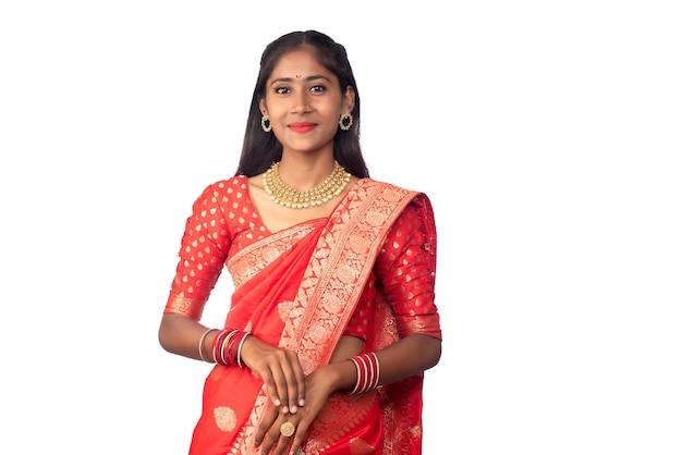 Portrait of a young girl on Indian traditional saree posing on a white background