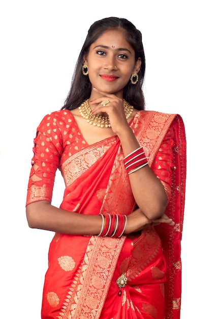 Portrait of a young girl on Indian traditional saree posing on a white background