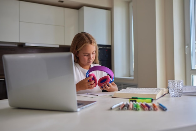 Photo portrait of a young girl listening to music at home