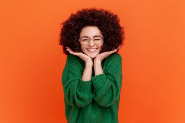 Portrait of young girl on orange background