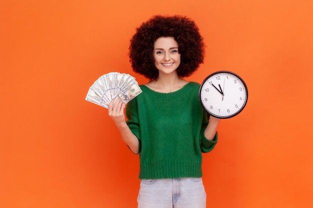 Portrait of young girl on orange background