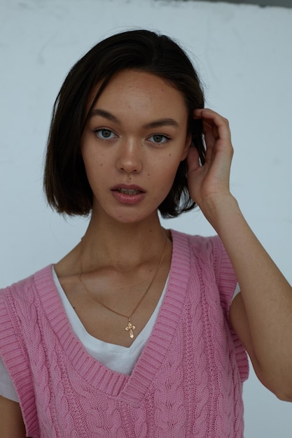 Portrait of a young girl in a pink vest closeup charm