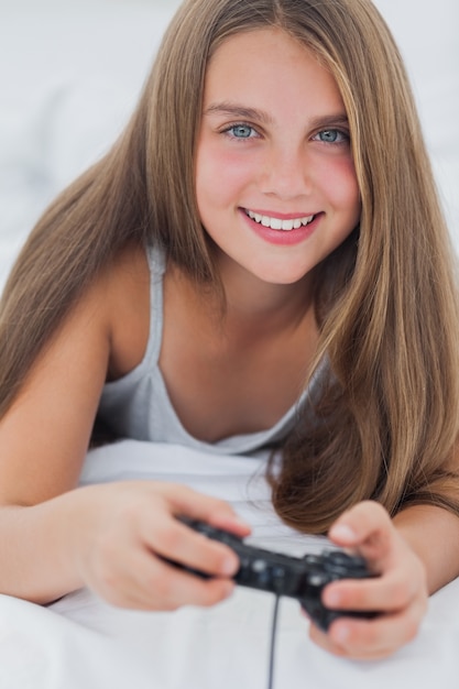 Portrait of a young girl playing video games 