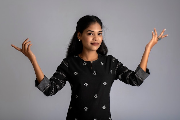 Portrait of a young girl posing on gray background