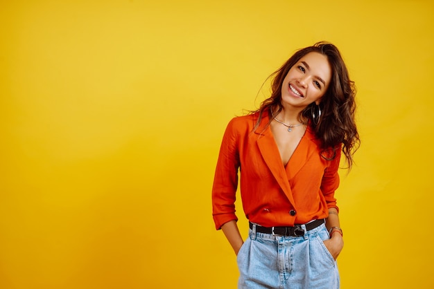 portrait of young girl posing on yellow.