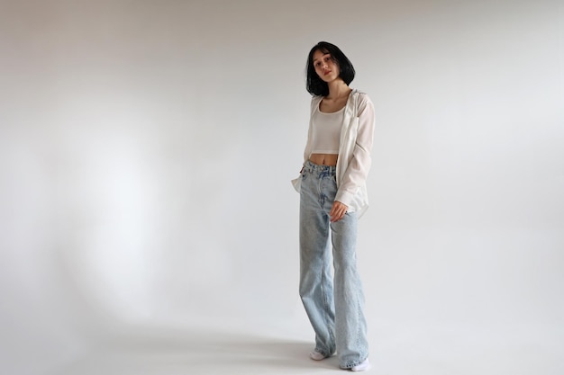 Portrait of a young girl a teenager on a white background copyspace