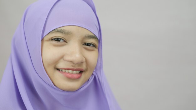 Portrait young girl wear purpel hijab on white background.