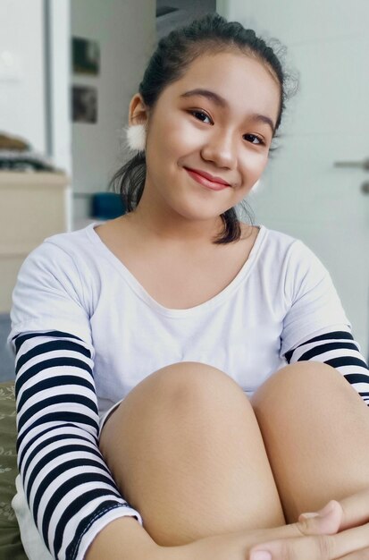 Photo portrait of a young girl wearing a black and white striped casual outfit