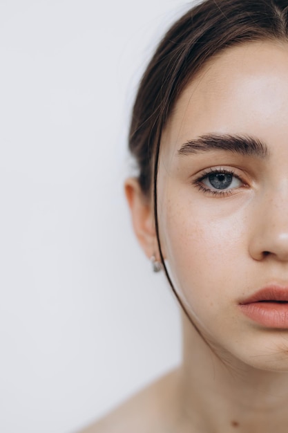 Portrait of a young girl with clean skin without makeup stylish minimalism and girlish beauty