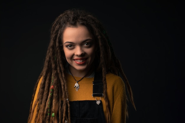 Portrait of a young girl with dreads on black 